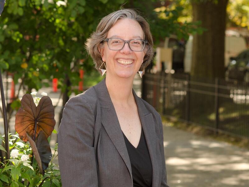 A photo of a woman standing outside. 