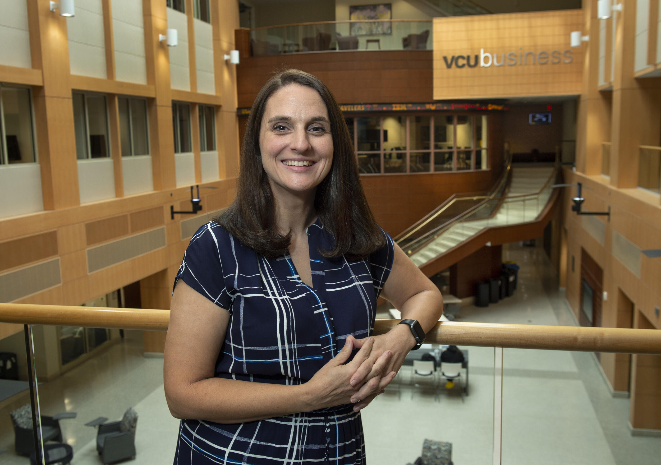 A woman leaning against a railing 