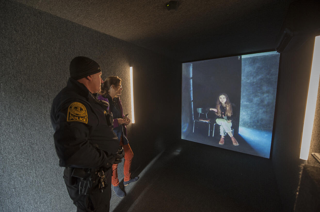 A VCU police officer and Karen Manning, Richmond portal ambassador, speak with a person in Oakland, California. 