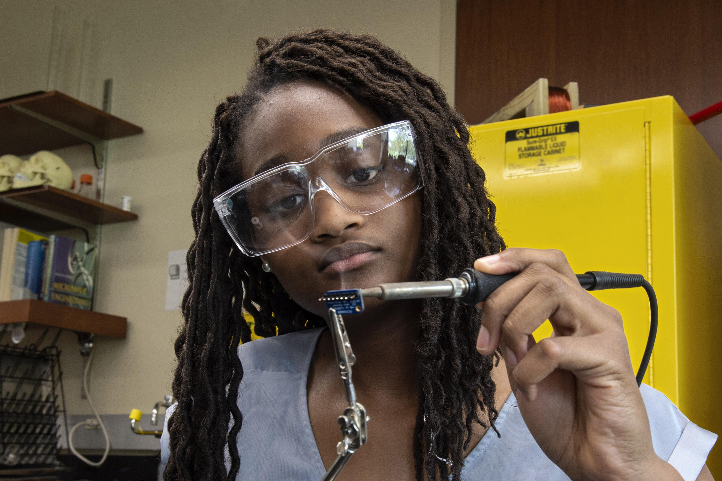 Alexandra Wright solders pinheaders on a temperature sensor at a VCU electrical engineering lab. (Photo by Kevin Morley, University Relations)