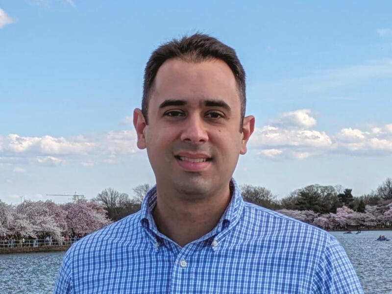 A photo of a man from the shoulders up. 