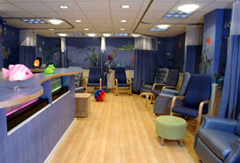 The large treatment room provides an underwater escape through colorful aquatic murals and a bubbling neon fish tank. Video games, books and toys also help children pass the time while they receive care.
