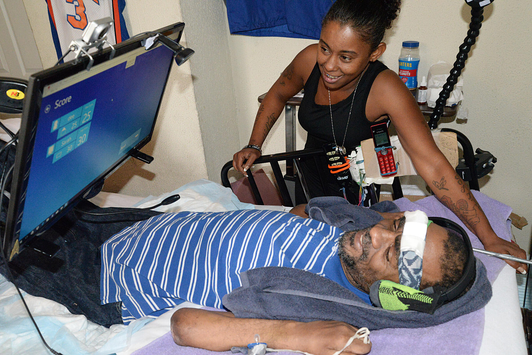 Derrick Bayard and his former home care attendant, Latoya Harvey, at his home in Richmond. 
<br>Photo by Leha Byrd, University Public Affairs.