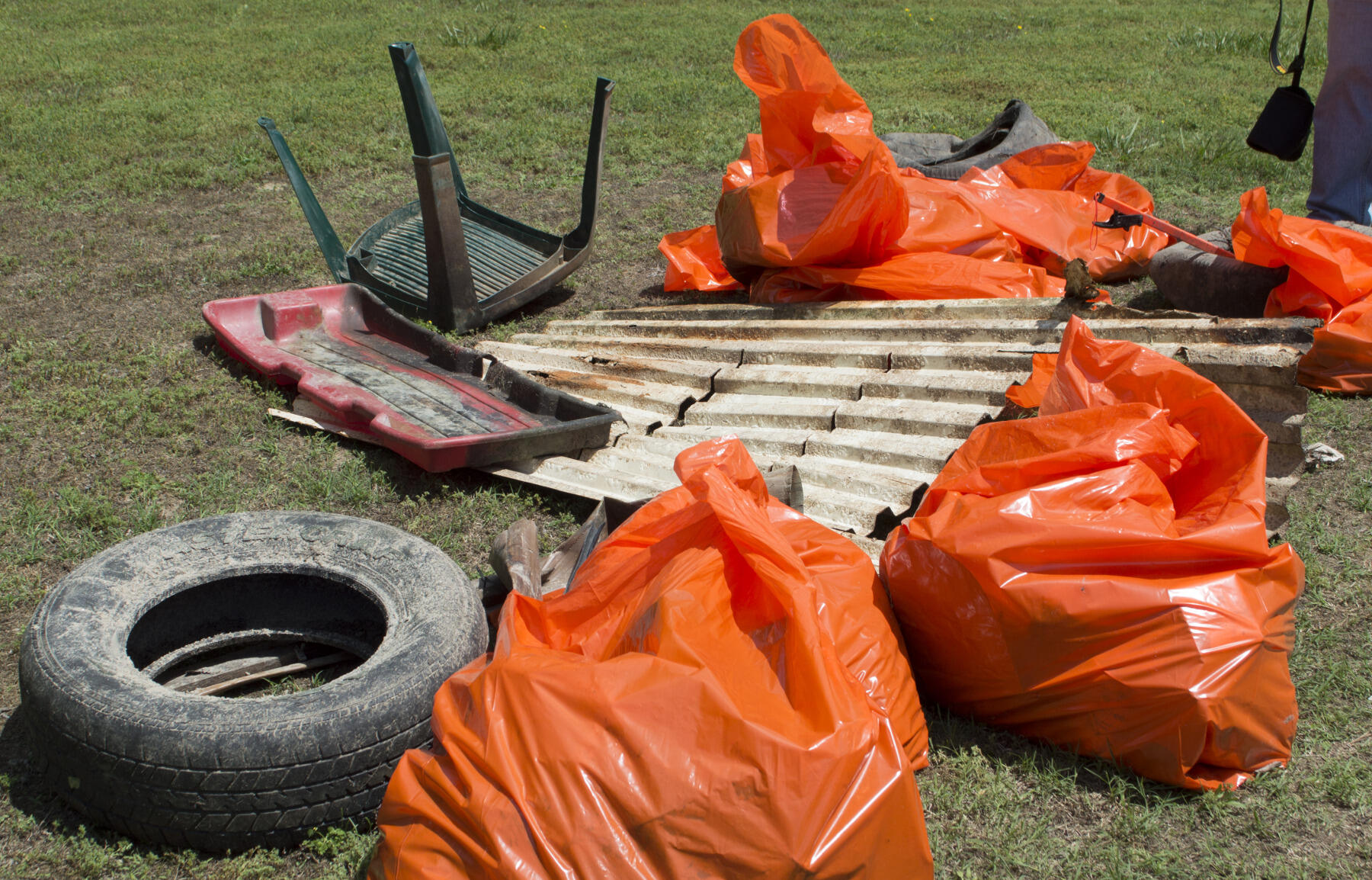 The volunteers pulled 15 bags of garbage, four car tires, a child’s sled, a patio chair, an old Polaroid camera and a large sheet of corrugated metal away from the stream.