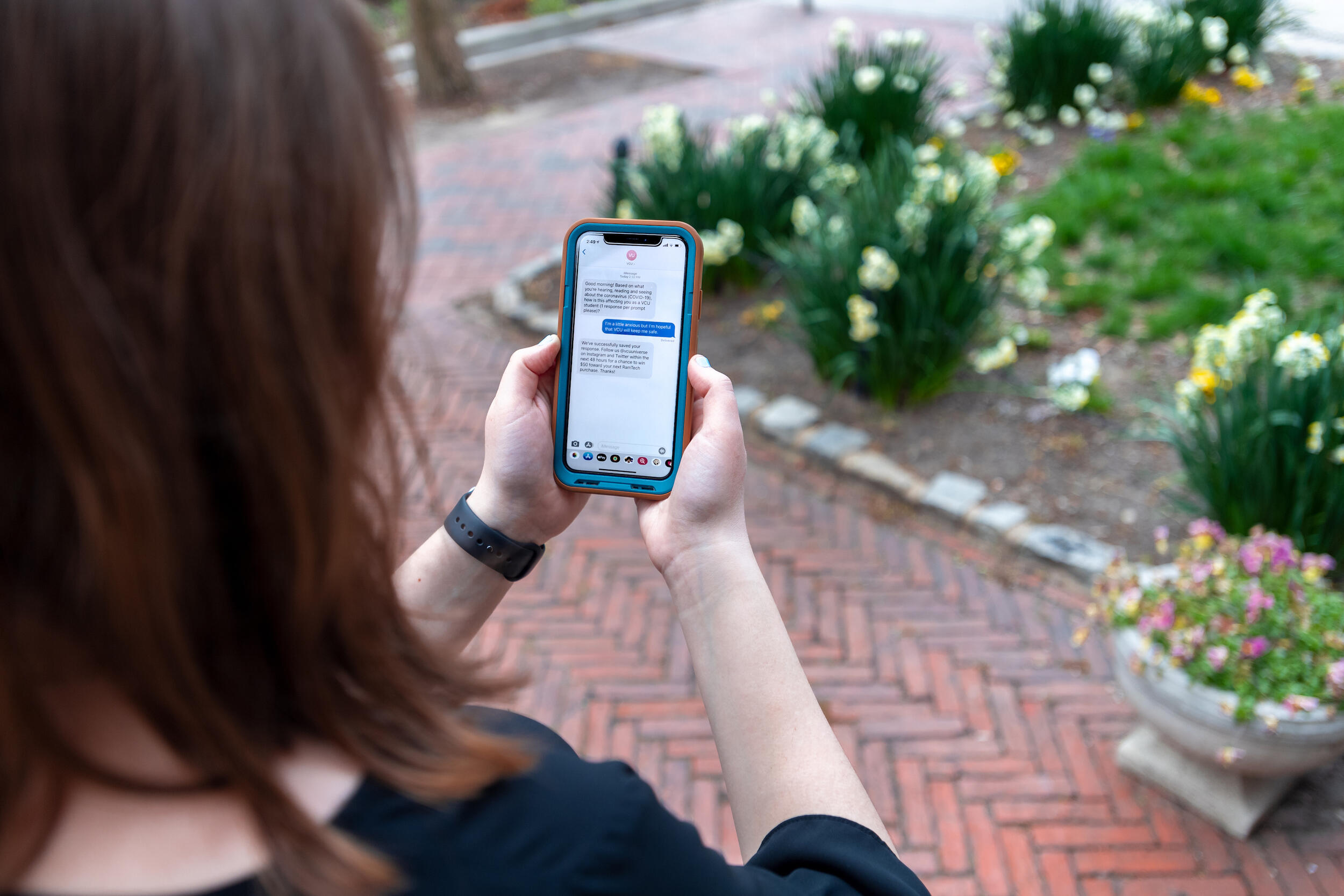 A person reads a text message on a cell phone.