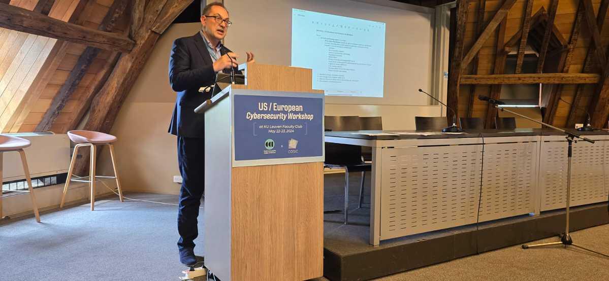 A man speaks at a lectern with an American flag in the background.
