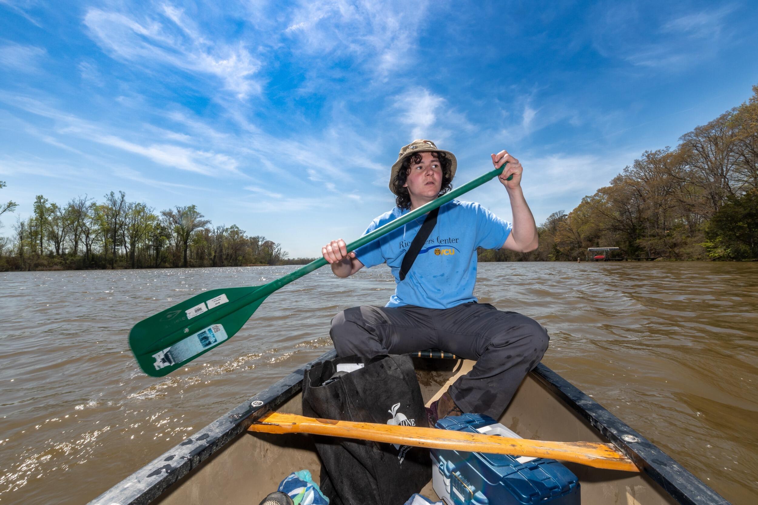 Juniper Peterson rows a canoe in the James River.