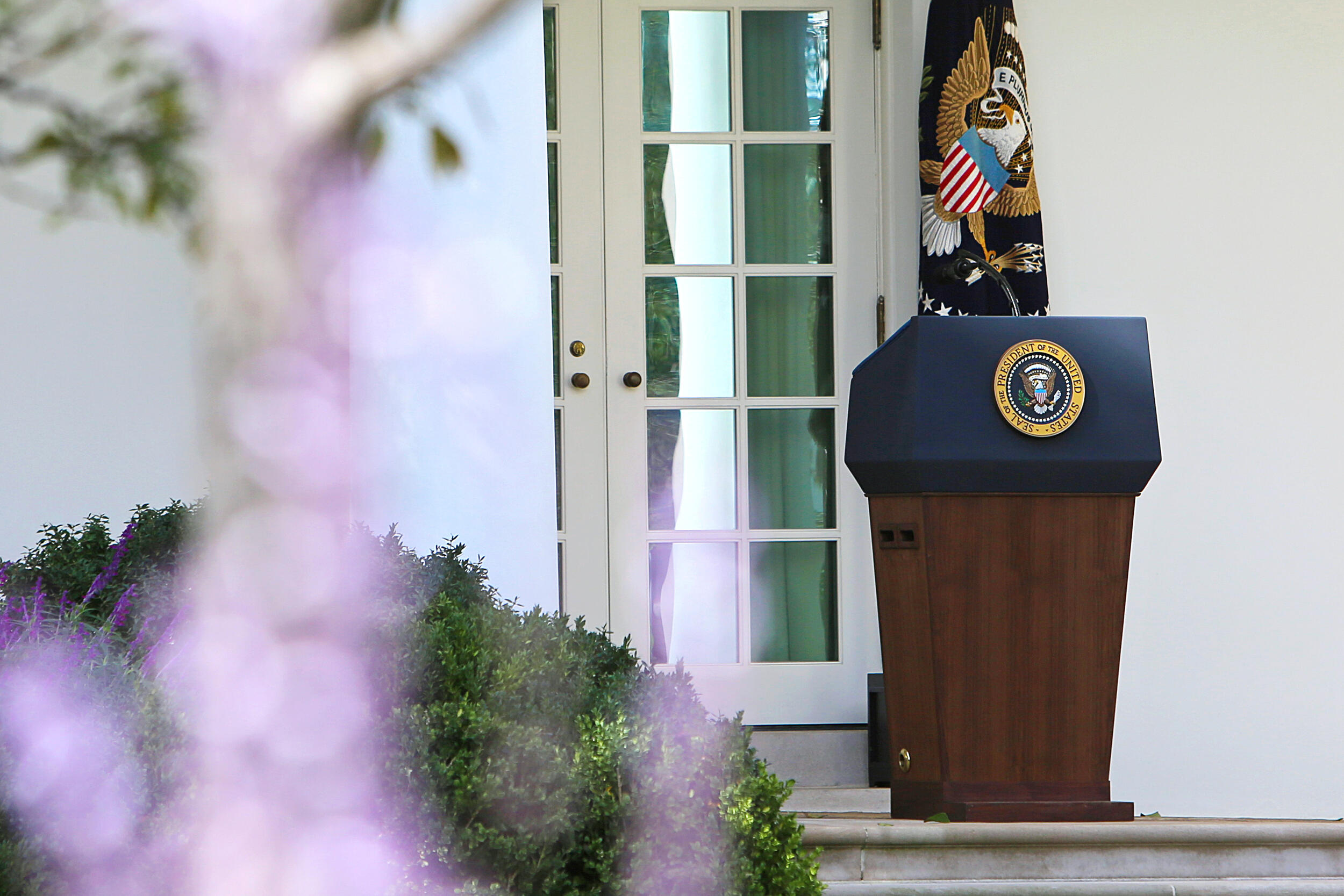 The press podium with the U.S. Presidential emblem on it. 