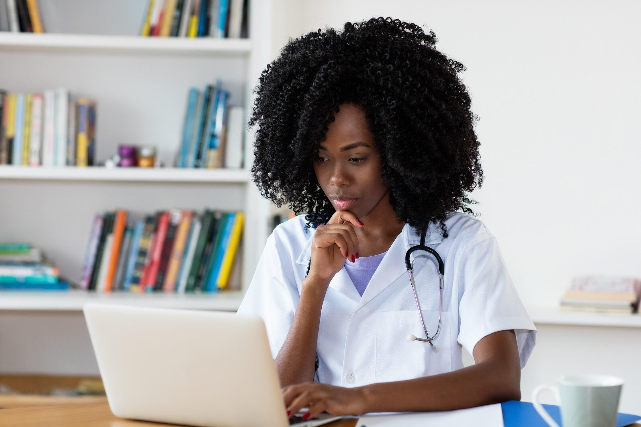Nurse looking at a laptop (Photo: Getty Images)