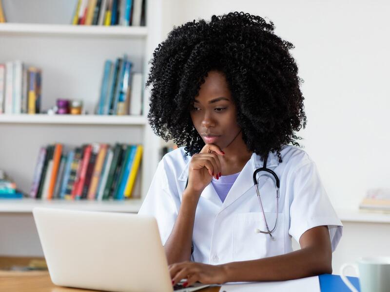 Nurse looking at a laptop (Photo: Getty Images)