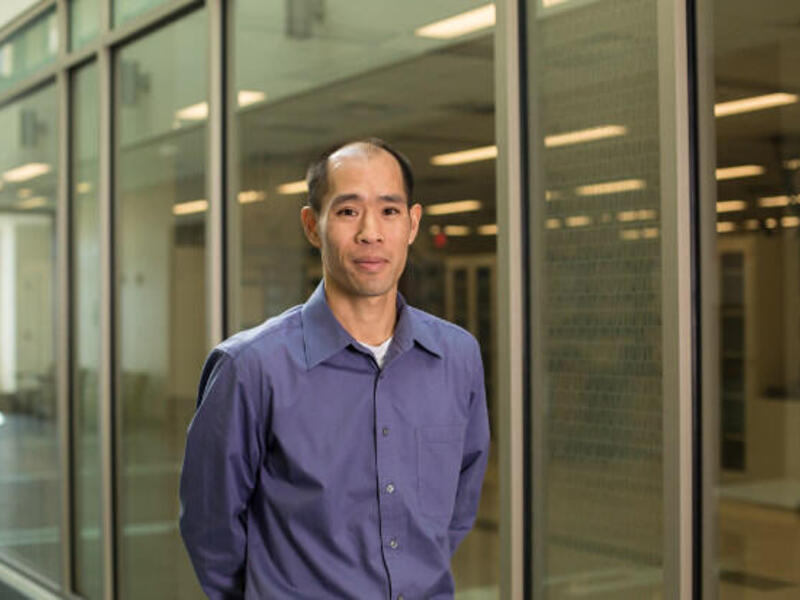 Man standing in blue shirt.