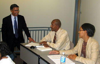 Learning from their professor and from each other. From left, Professor Dale Jones, Ph.D., shares a laugh with Victor and Jessica Williams. The father and daughter from Chesterfield County will receive master’s degrees in criminal justice during VCU’s fall commencement.  Photo by Mike Porter/ VCU Office of University News Services. 