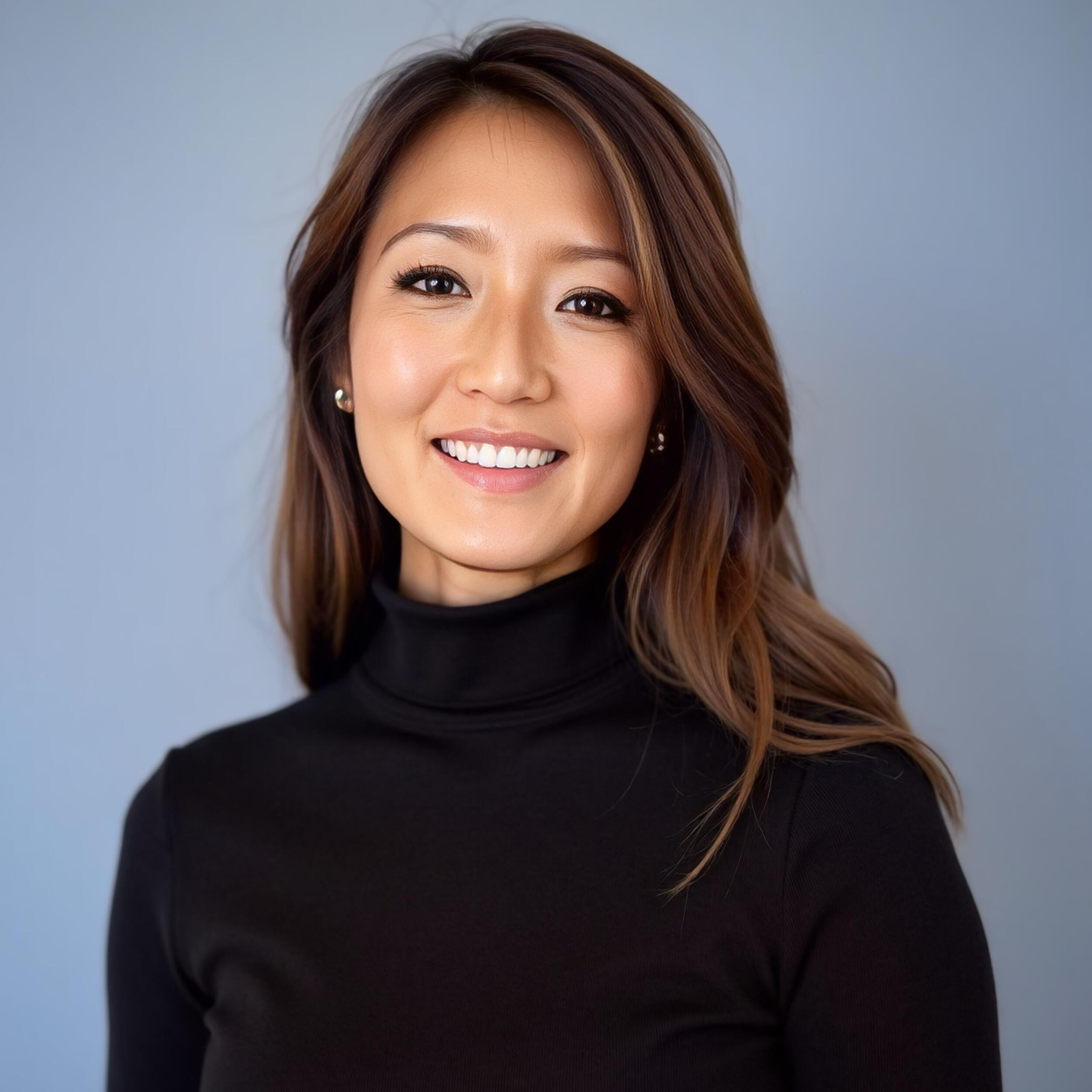 A photo of a woman from the shoulders up. 