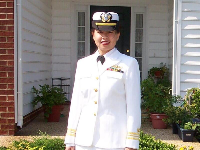 A photo of a woman wearing a white military uniform 