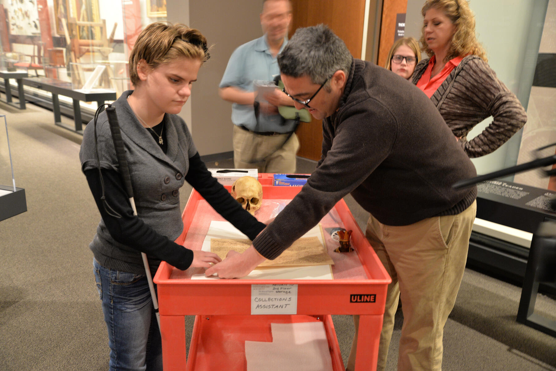 Kimmy Drudge (left), a visually impaired 14-year-old, feels George Washington's signature, 3-D printed at a VCU lab off of a document at the Virginia Historical Society. 
