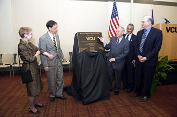 Unveiling the dedication plaque. From left: Michele A. Romano, M.D., vice rector; Sheldon M. Retchin, M.D., M.S.P.H., VCU vice president for Health Sciences and VCU Health System CEO; Eugene P. Trani, Ph.D., VCU president and president and chair of the Board of Directors, VCU Health System; U.S. Rep. Bobby Scott; and Dr. Jerome F. Strauss III, M.D., Ph.D., dean, VCU School of Medicine