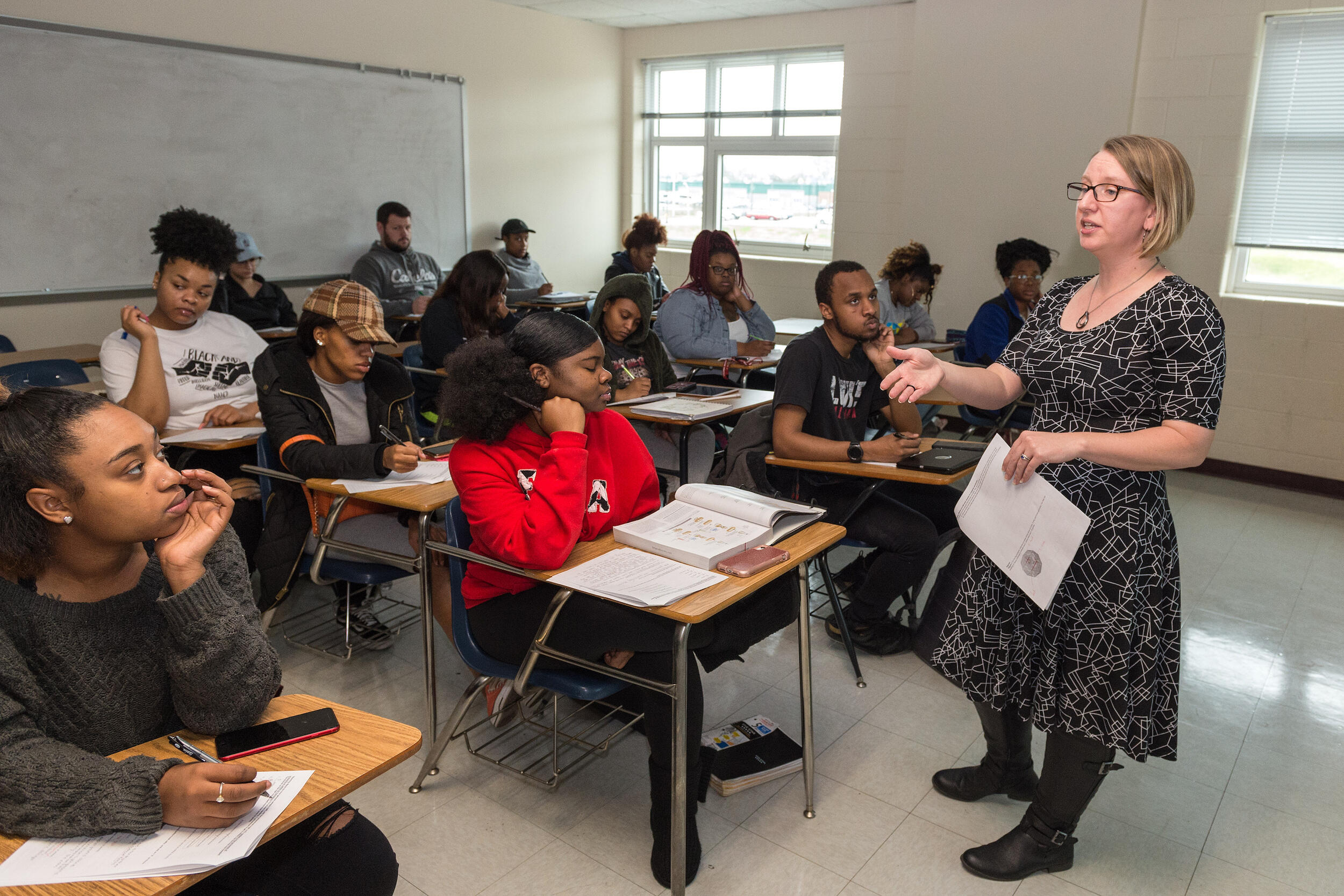 A professor speaking to a classroom of students.