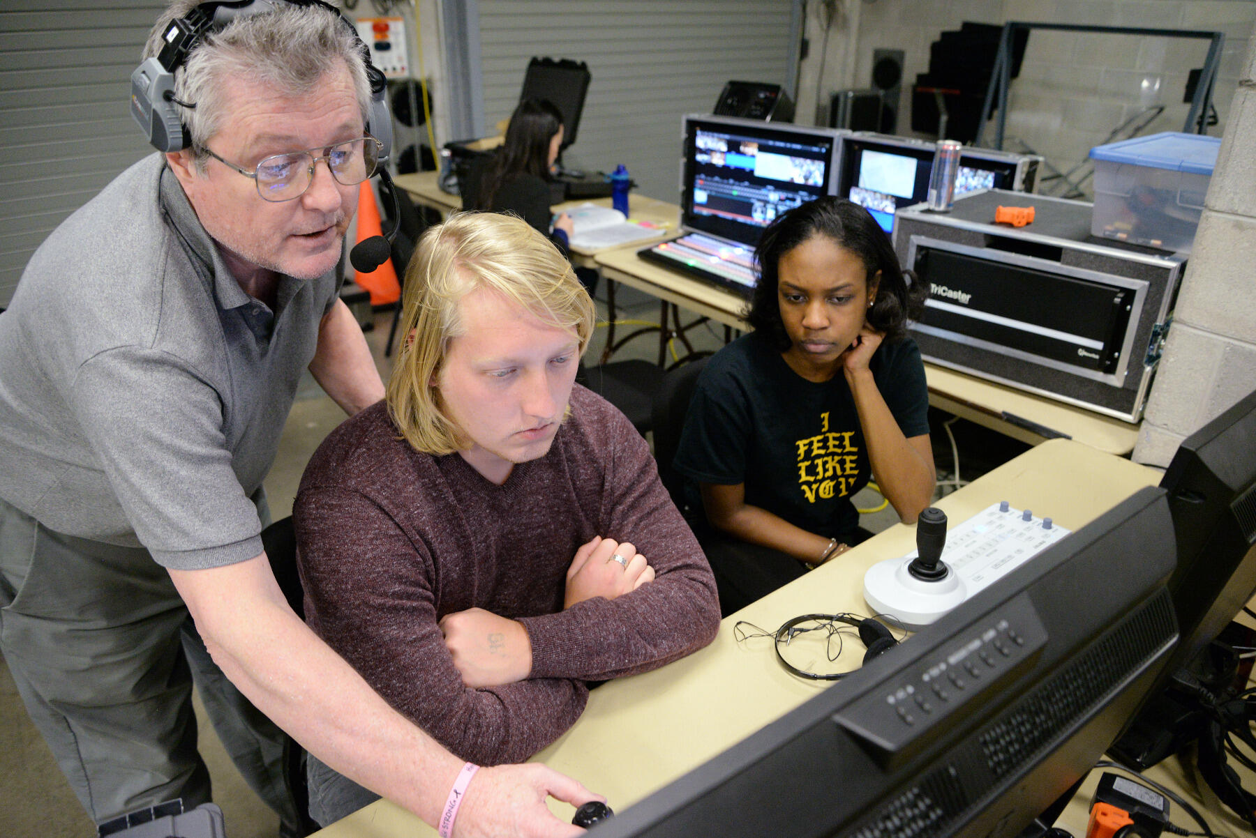 Gary Gillam, director of production services at the Richard T. Robertson School of Media and Culture in the College of Humanities and Sciences, gives direction to broadcast journalism majors Niyah Coles and Sean Boyce.