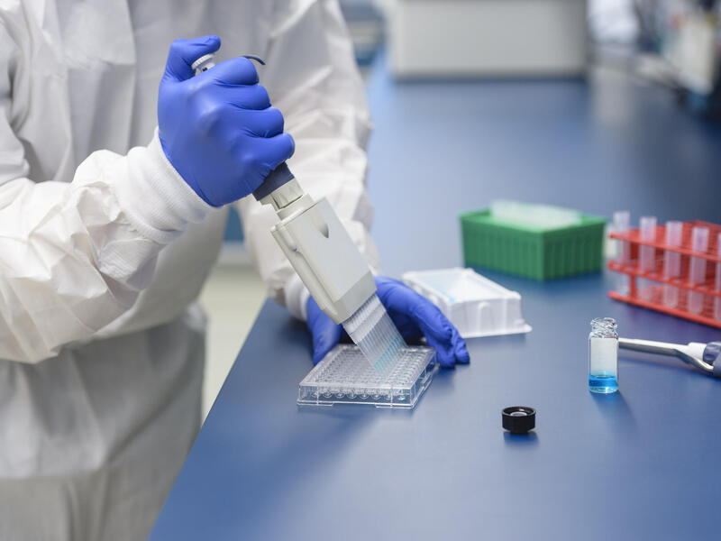 A researcher conducts lab work in the VCU School of Pharmacy.