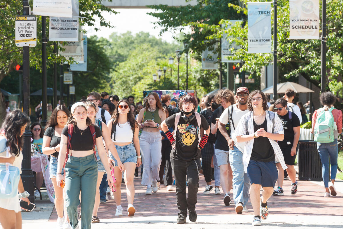 A group of students walking through Monroe Park campus