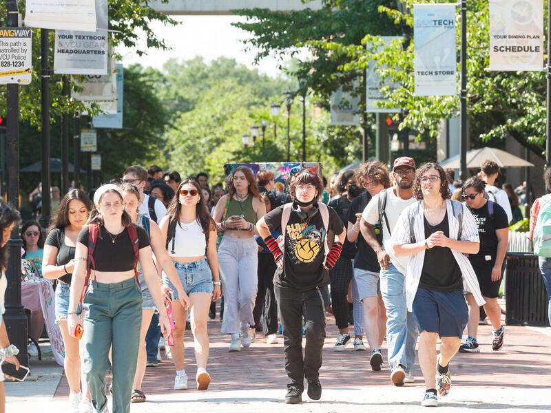 A group of students walking through Monroe Park campus