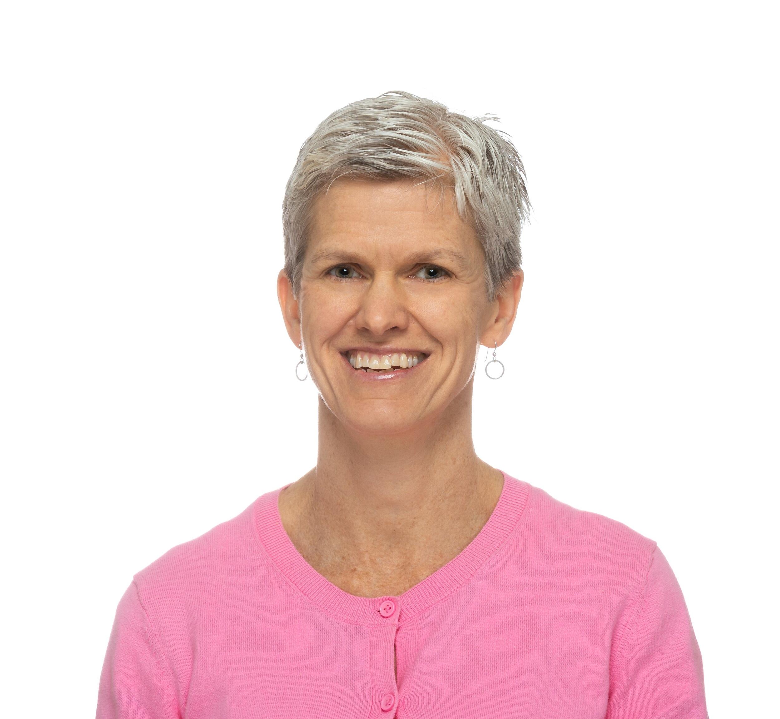 MaryPeace McRae, Pharm.D., Ph.D. smiling and wearing a pink cardigan 