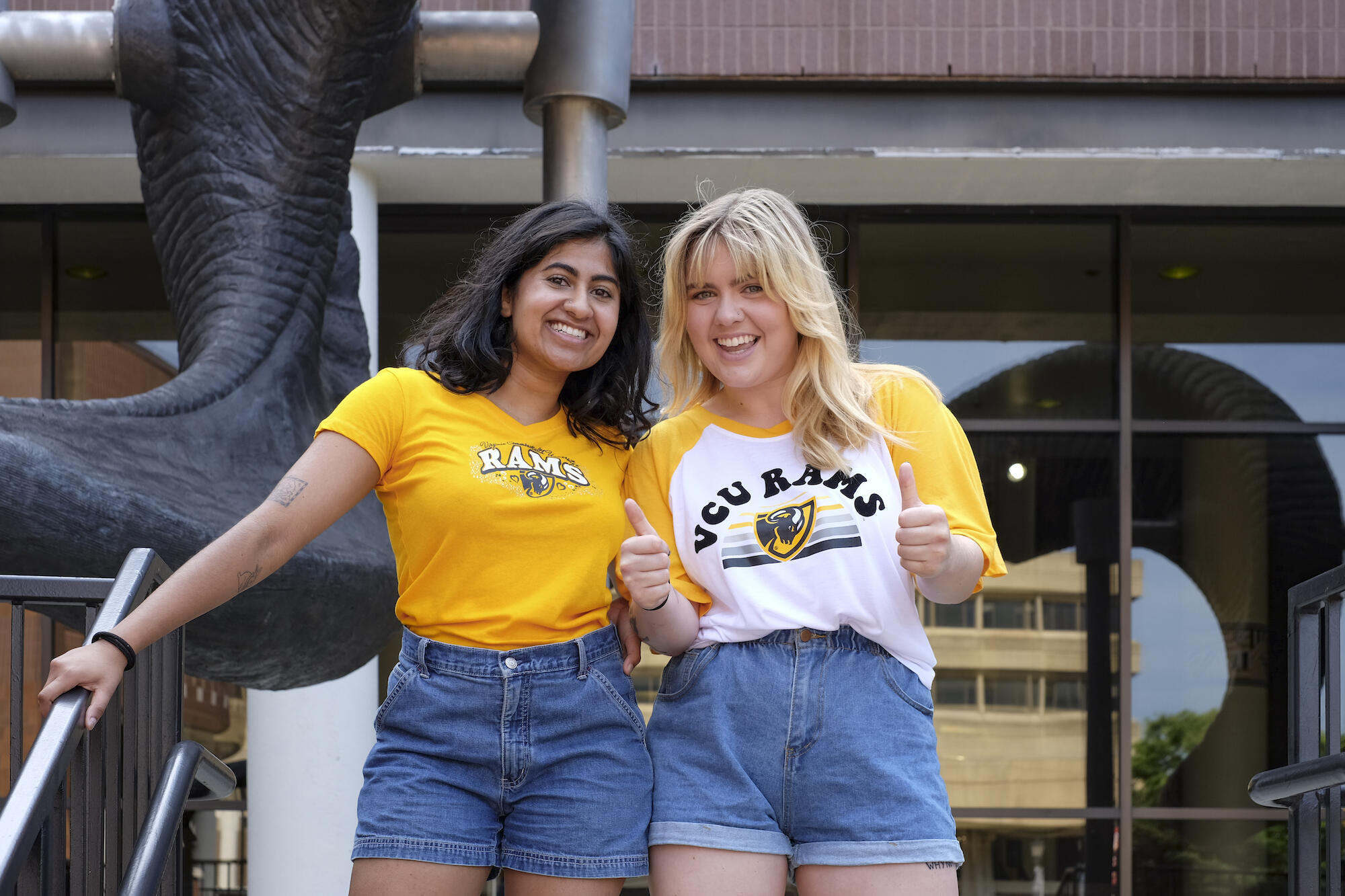two VCU students standing in front of the ram horns 