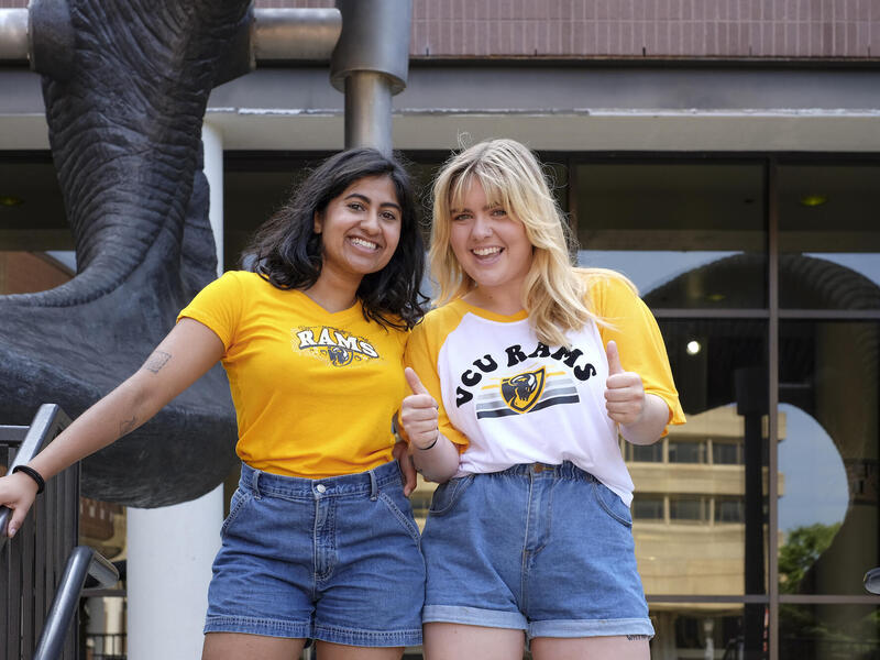 two VCU students standing in front of the ram horns 