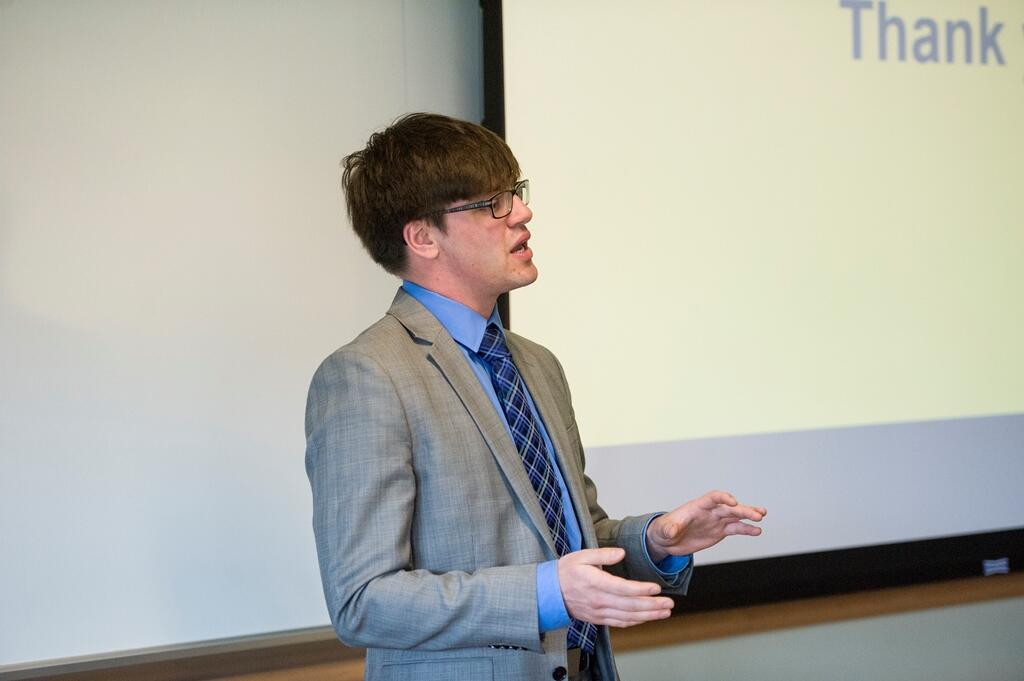 Senior Elliot Roth presents a business idea for replacing asphalt tiles with a biologically inspired alternative at the Venture Creation Competition. Photo by Tom Kojcsich, University Marketing.