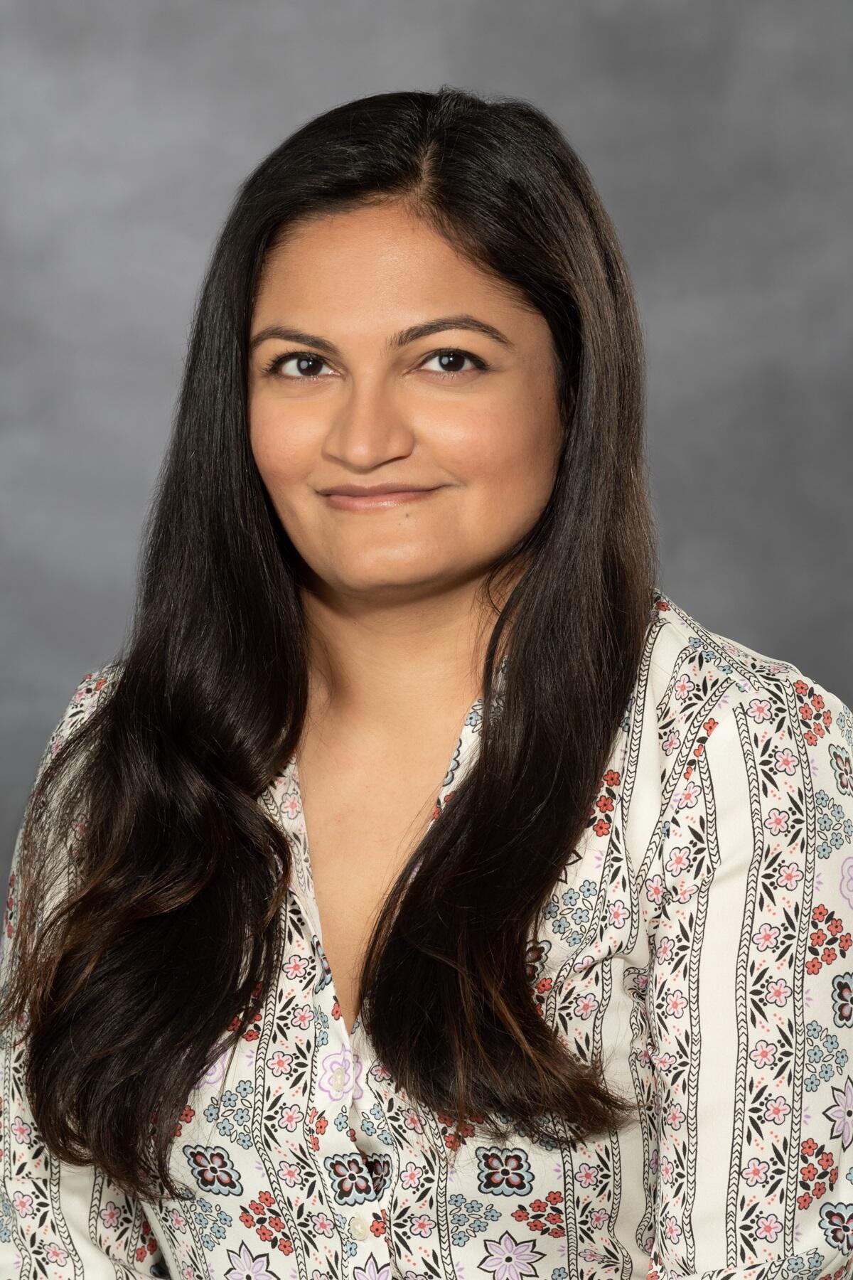 Headshot of Dr. Shruti Sayal against a gray background. 