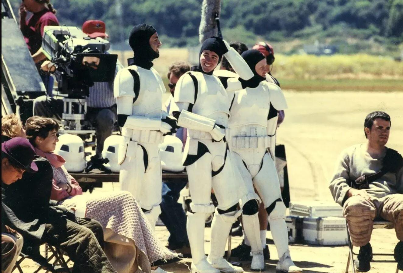 Men wearing storm trooper uniforms with their hats off 