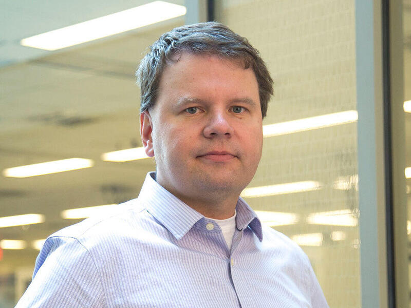 A photo of a man from the shoulder up. 