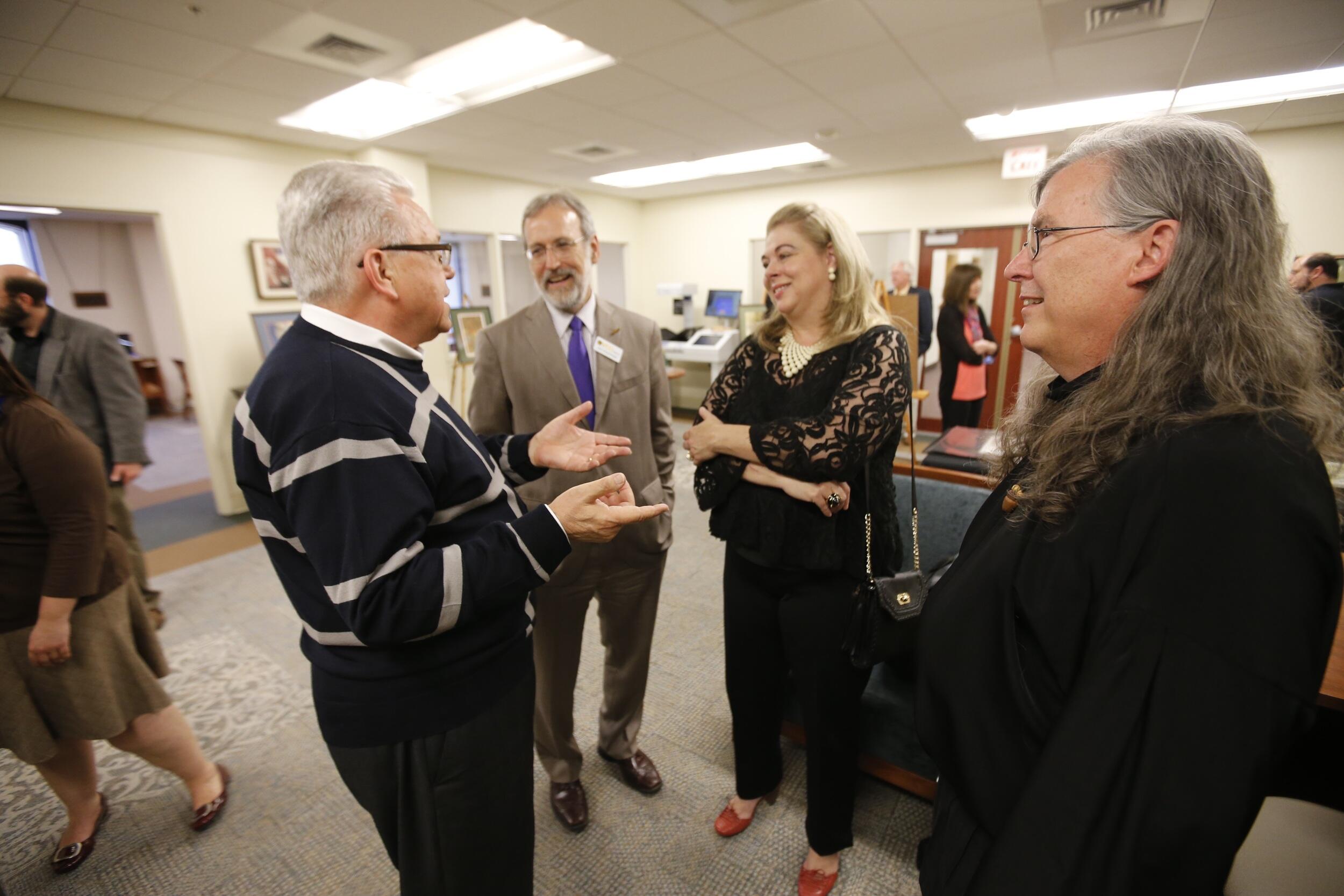 Four people in conversation.