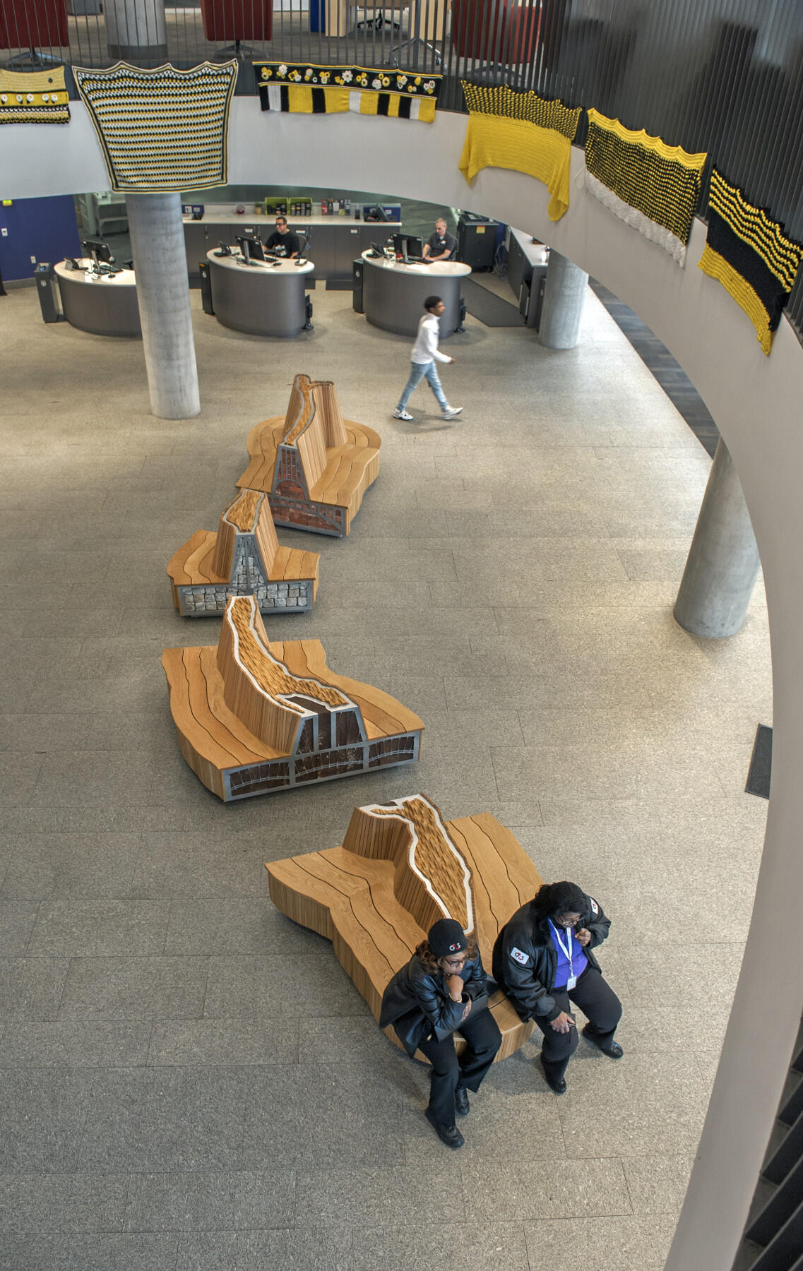 In four sections, the 27-foot-long bench feature three negative spaces, each representing a different iconic bridge of Richmond. Photo by Kevin Morley.
