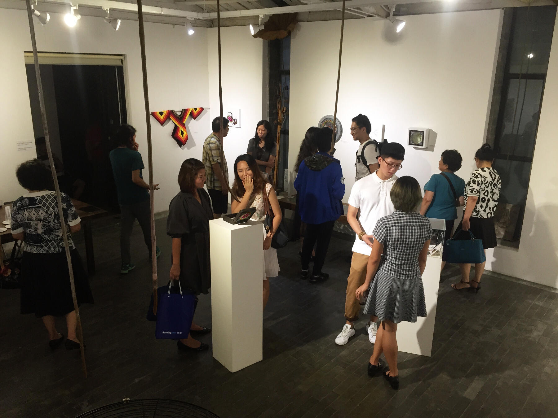 Visitors check out the artwork at "The Reviving Project" exhibition in Beijing, China.