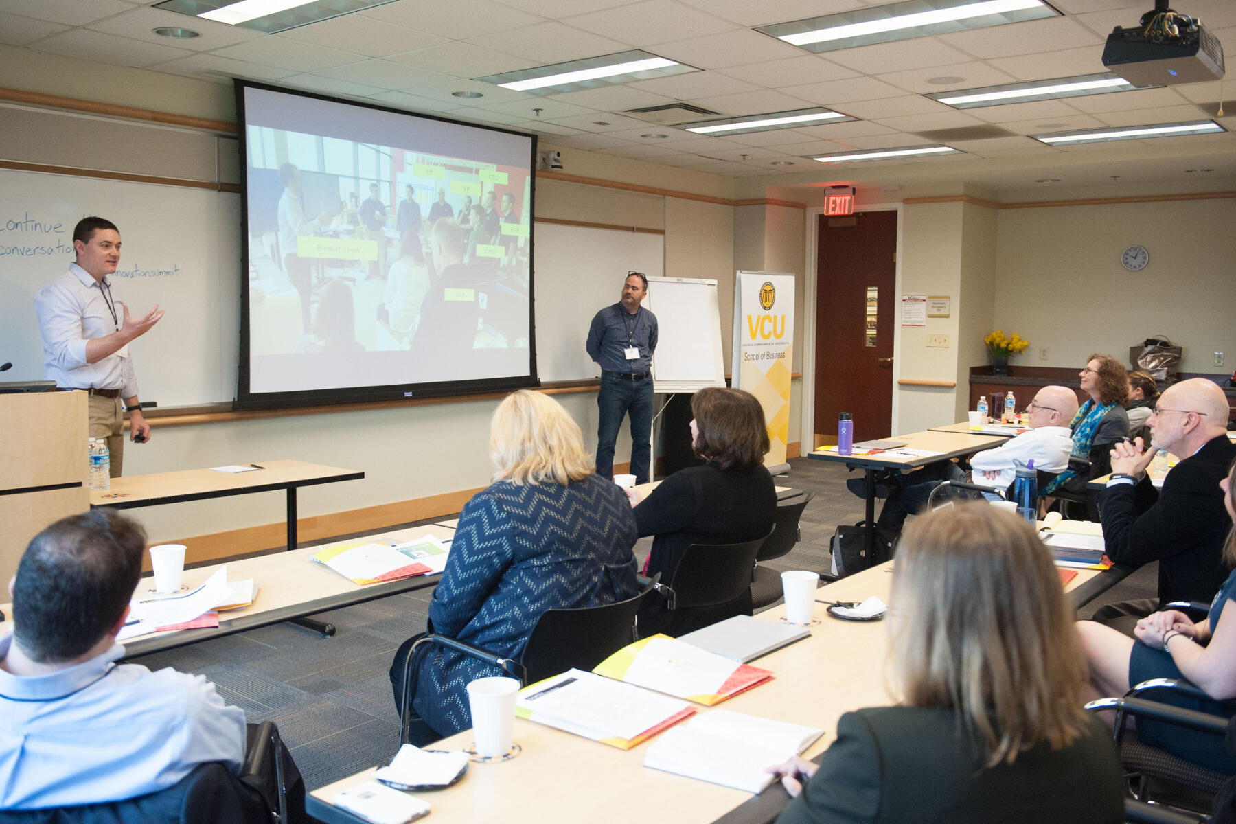 Eric Harrigan, Carmax's director of product management, and Chip Trout, manager of interaction design at Carmax, speak to attendees about igniting creativity in the workplace at the 2016 VCU Innovation Summit.