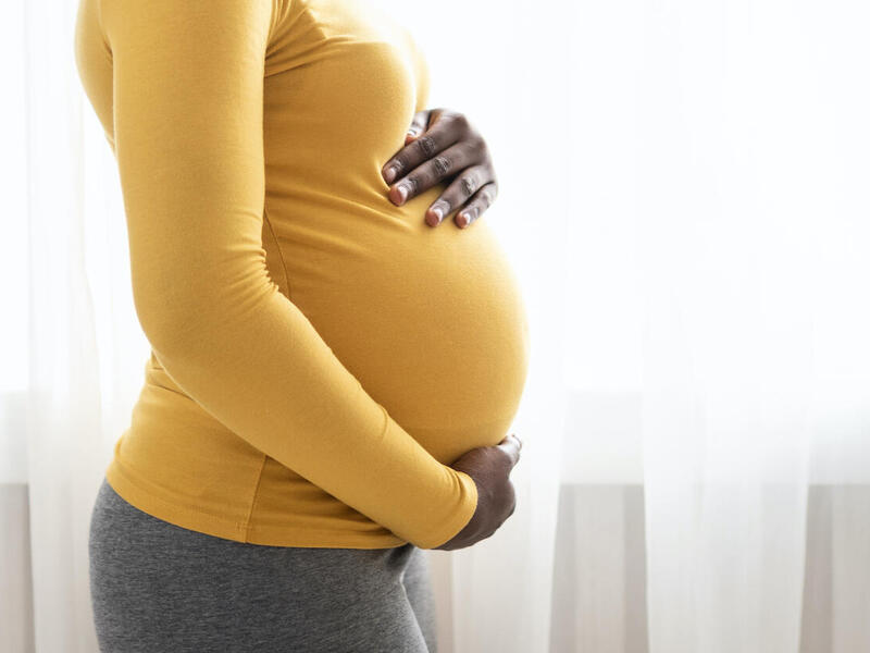 pregnant mother holding her belly