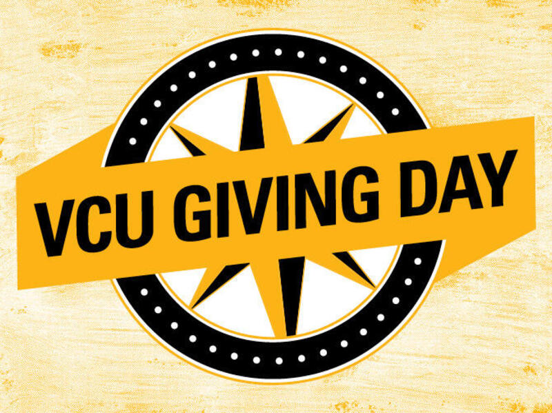 An illustration of a black and yellow compass with a yellow banner over it that says \"VCU GIVING DAY\" in black letters. 