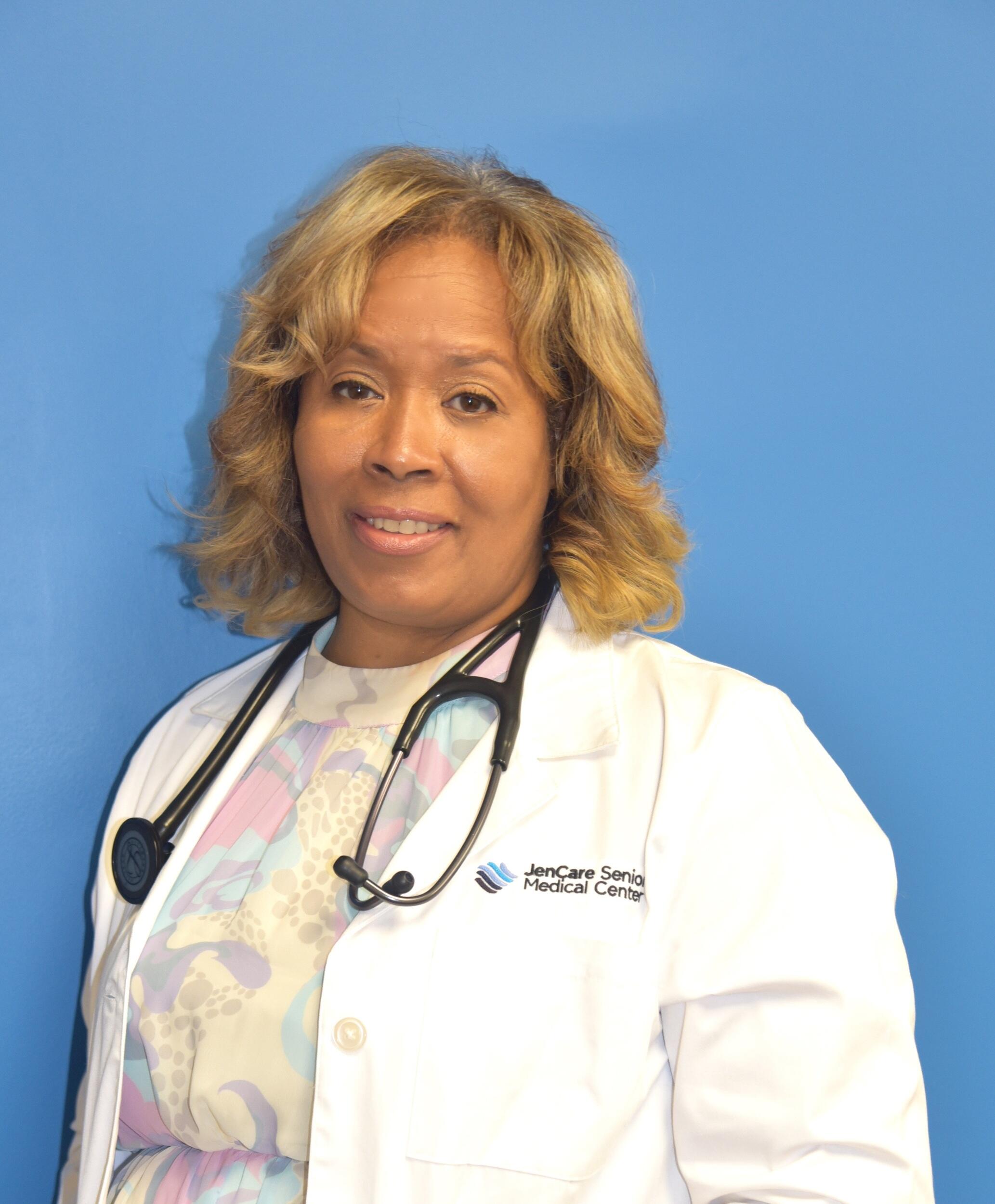 A portrait of Lisa Price Stevens wearing a doctor's coat and a stethoscope around her neck 