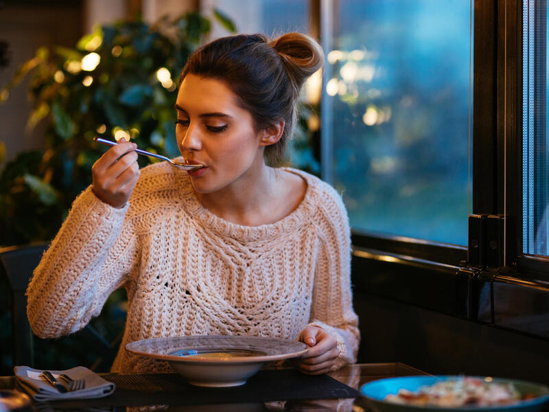 woman eating food from a bowl.