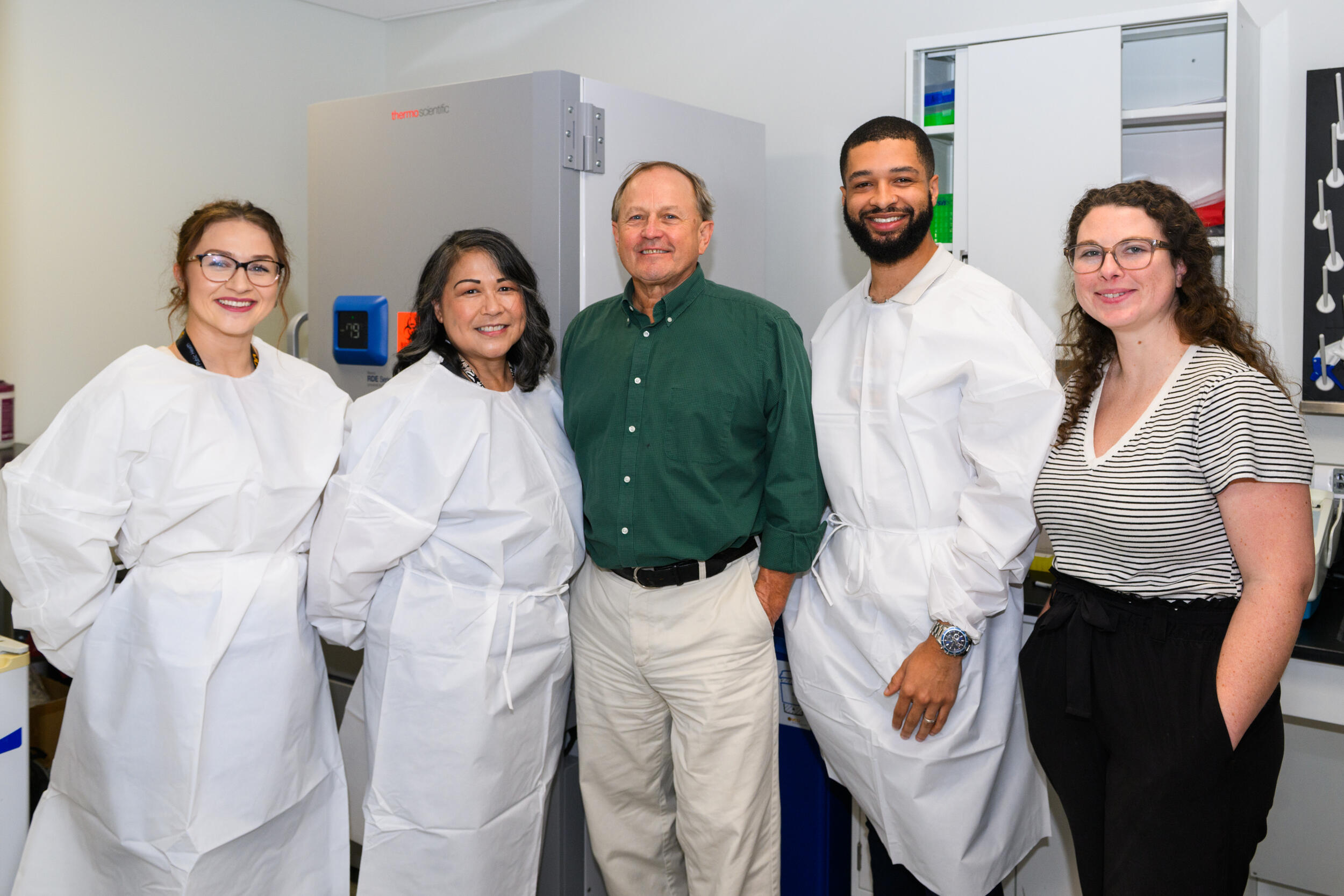 A group photo of five people standing. 