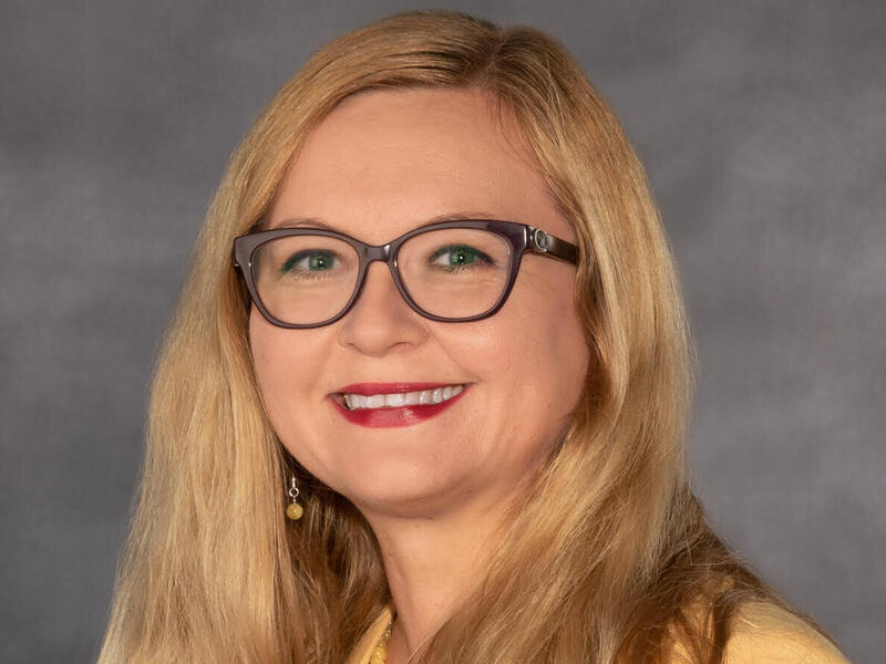 A photo of a woman from the chest up. 