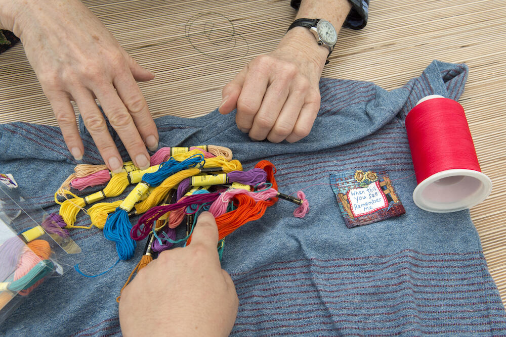 Scagnelli, a volunteer "mendor" of "The Mending Project," created patches to sew onto garments that don't need much mending. (Photo by Kevin Morley, University Relations)