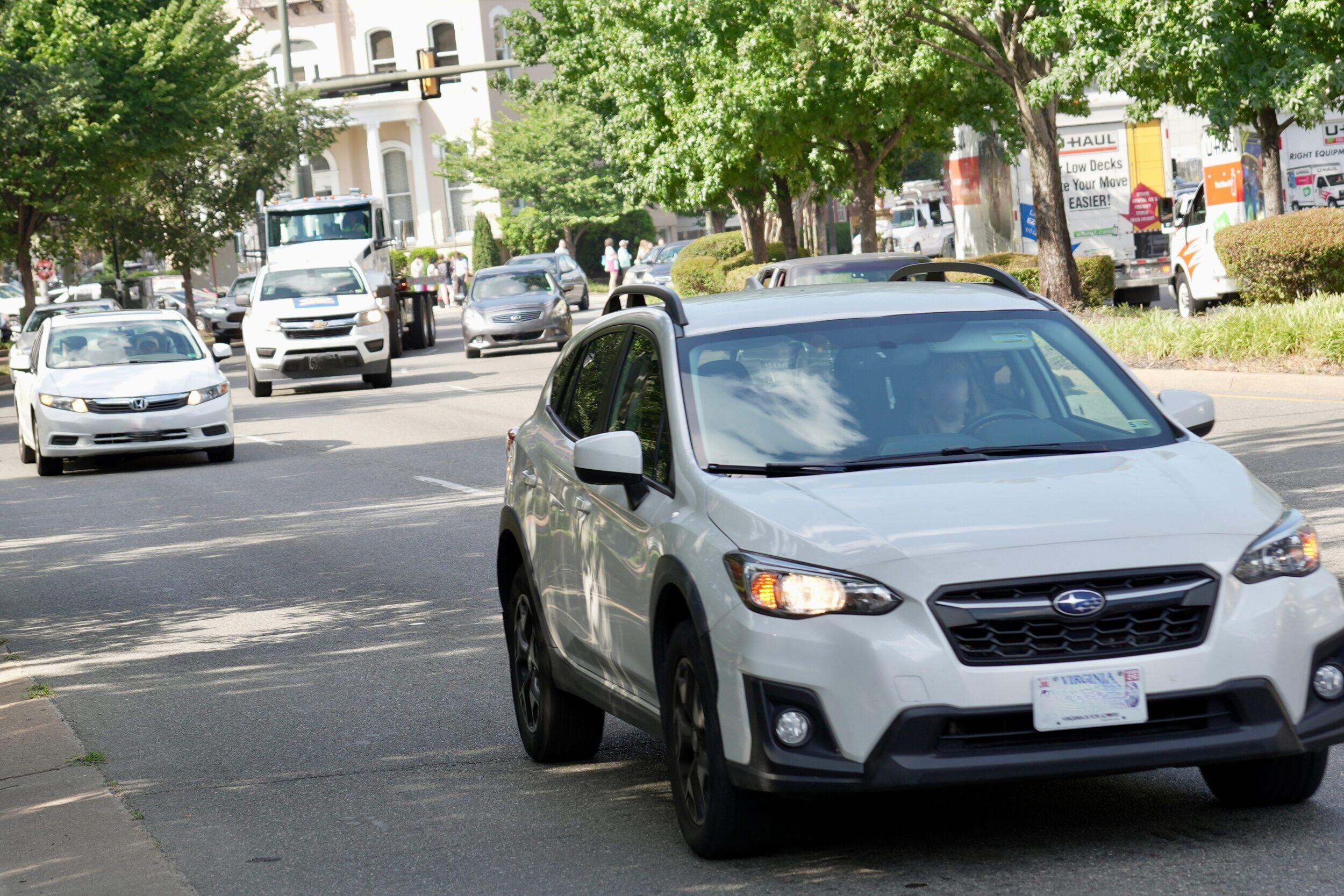 A photo of cars driving on a street. 