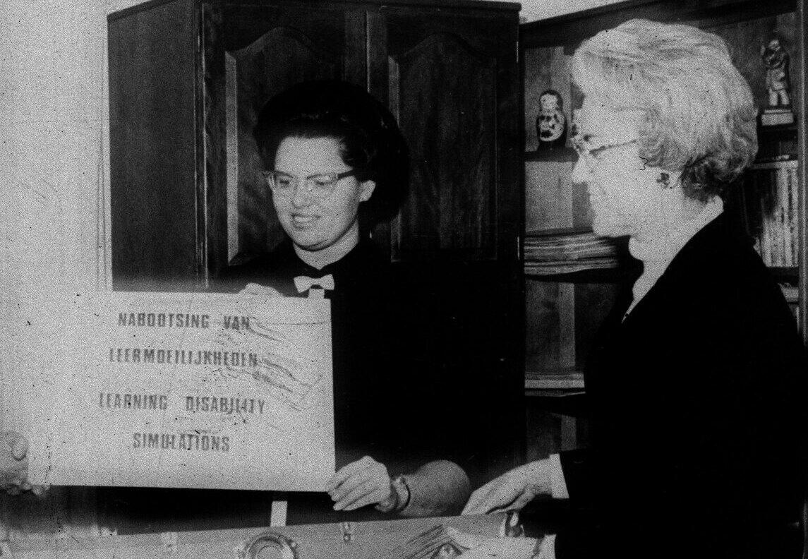 A black and white photo of two women 