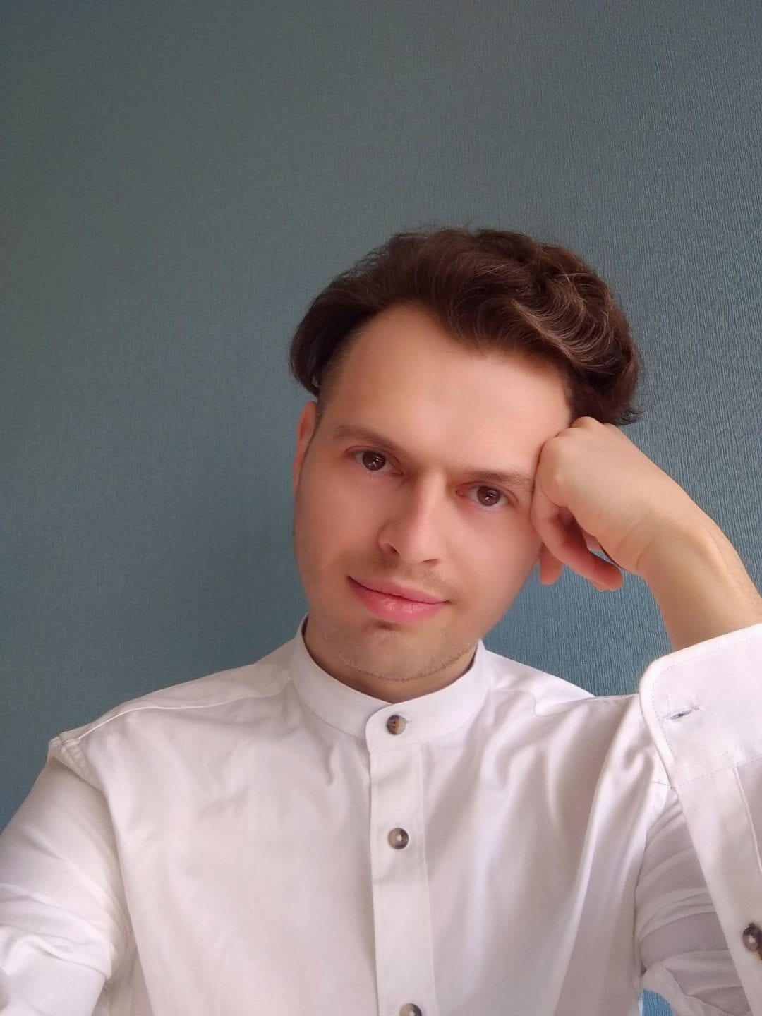 A portrait of a man resting his head on his hand