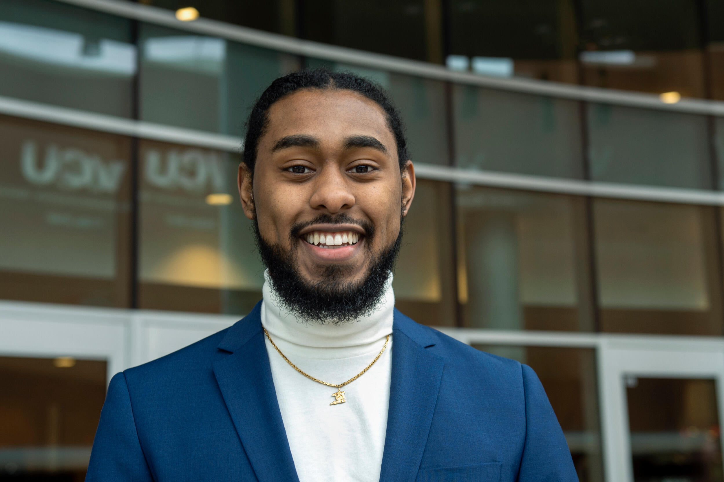 Portrait of smiling man with windows of building in background