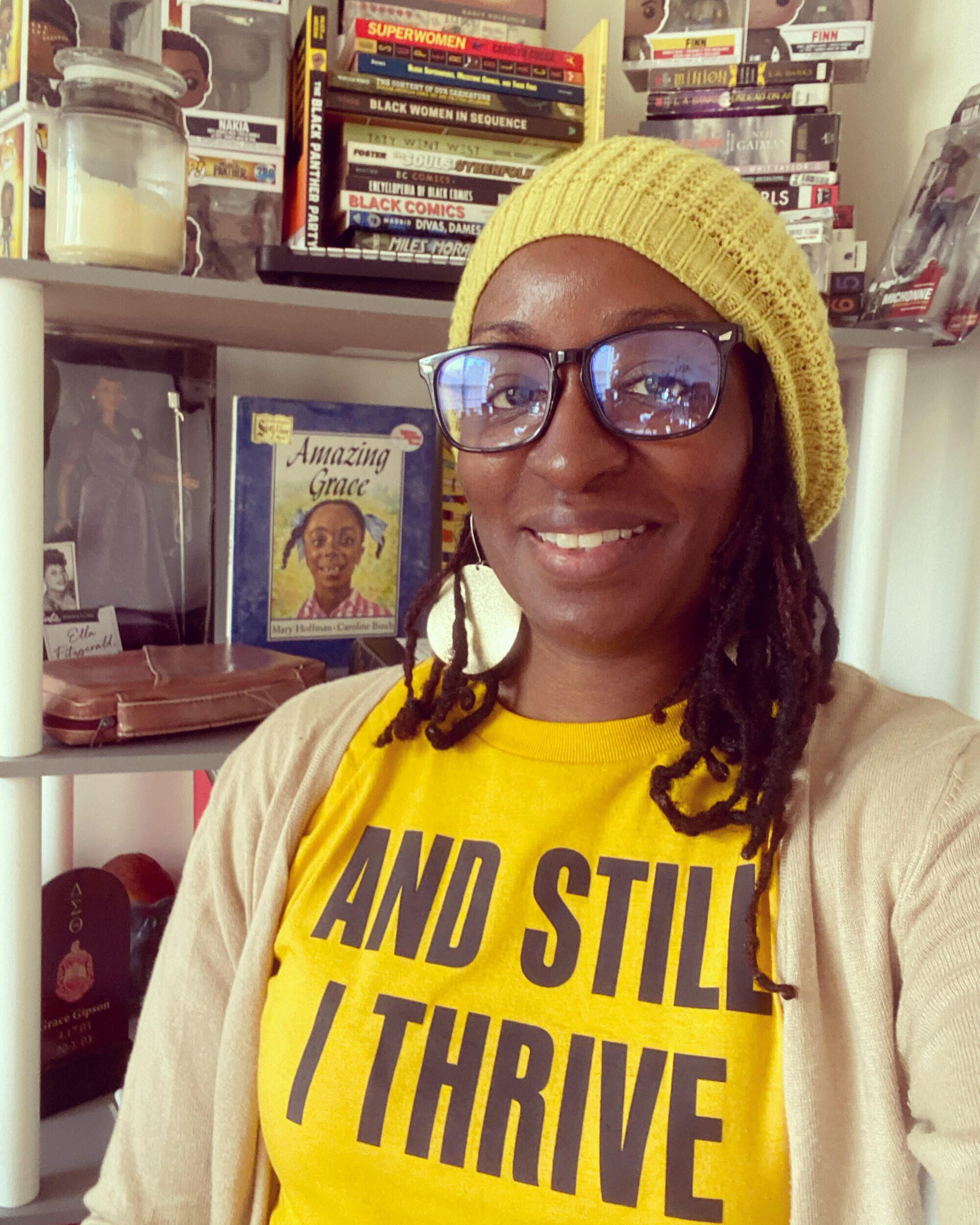 Grace Gipson wearing a shirt that says \"AND STILL I THRIVE\" 