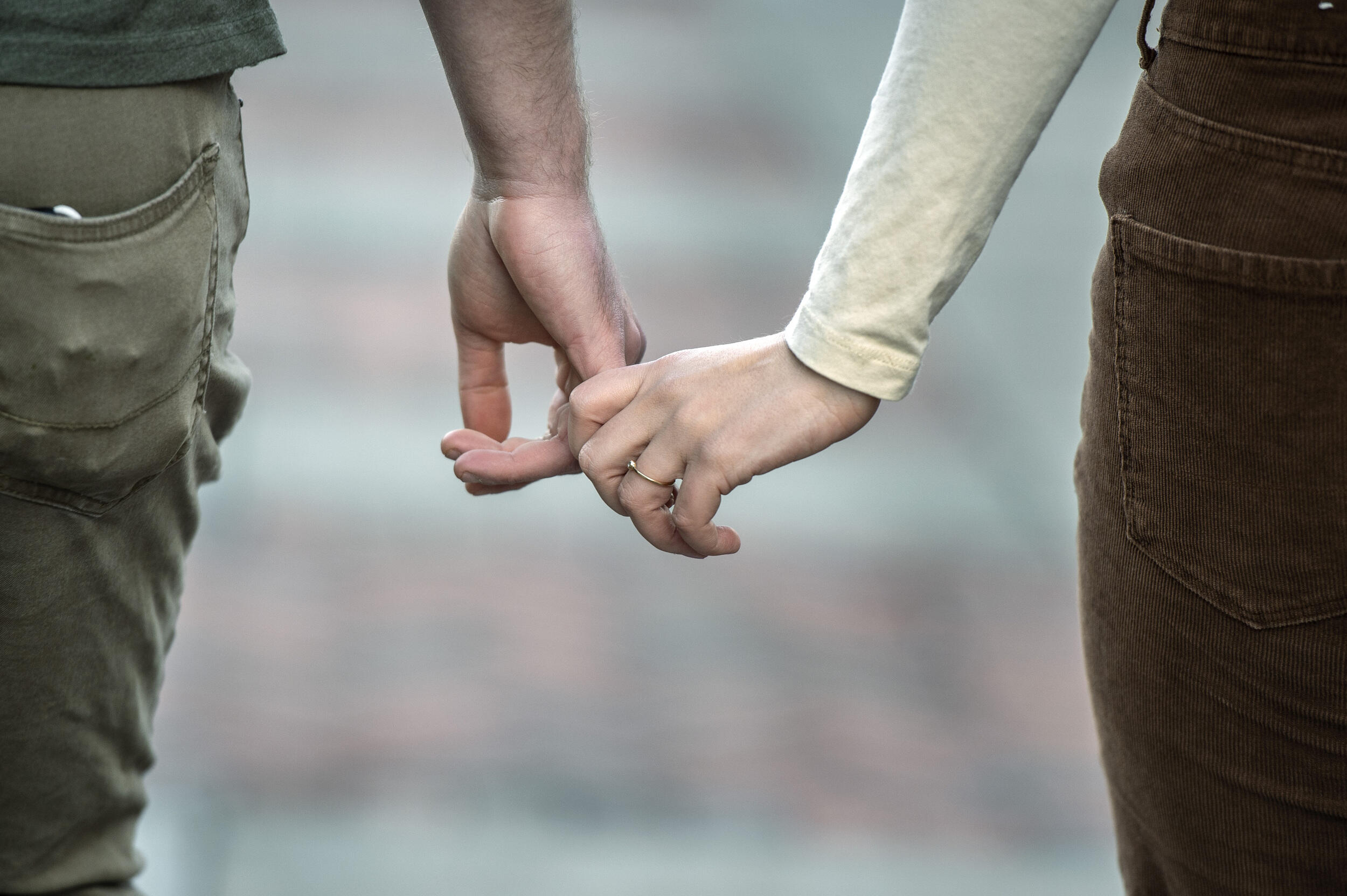 A photot of two people holding hands 