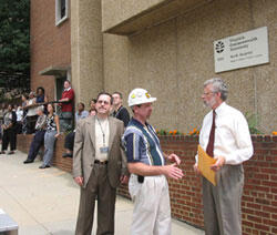 Out With the Old. More than three-dozen staffers and faculty at the VCU Medical Center gathered on the sidewalk along East Marshall Street to watch the demolition of Randolph-Minor Hall, including Capt. Grant Warren, director of security for VCU and the VCU Health System (left foreground), Joe Mannix, project manager, Department of Facilities and Management and Tony Mustain, assistant professor and administrator for the Department of Radiation Oncology.